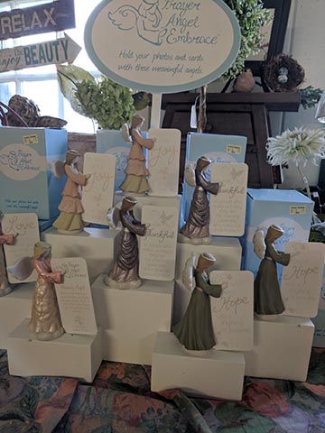 Angels holding cards with quotes on them