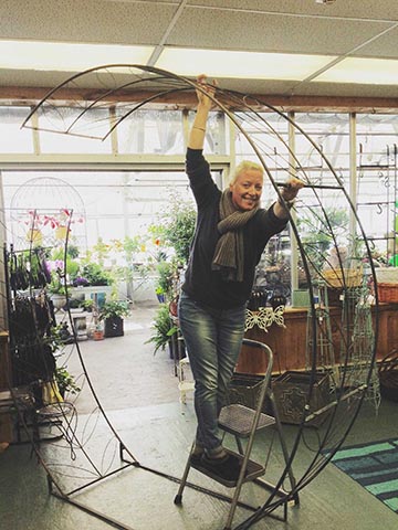 woman assembling a circular trellis